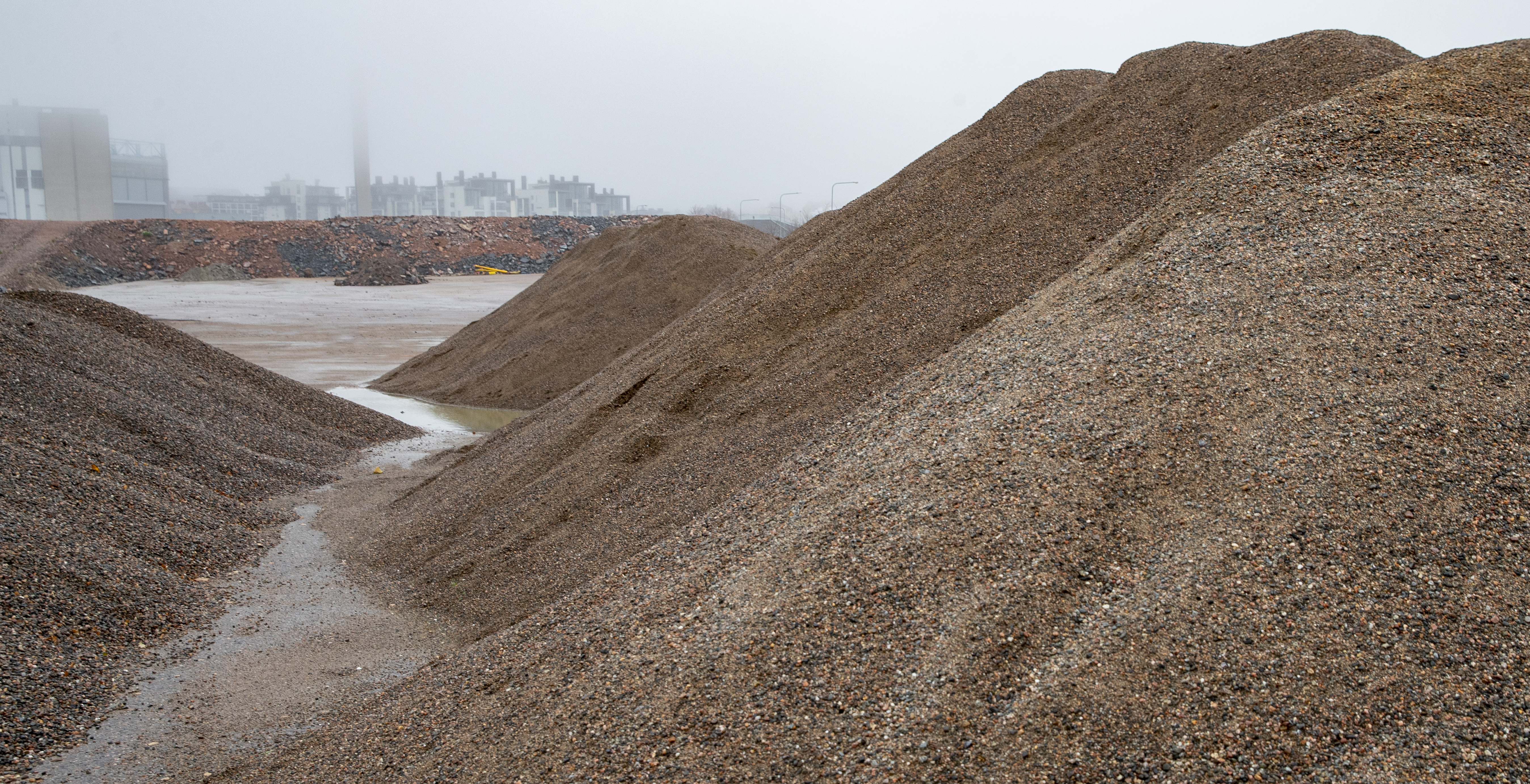 Piles of stone screened into fractions of different sizes.