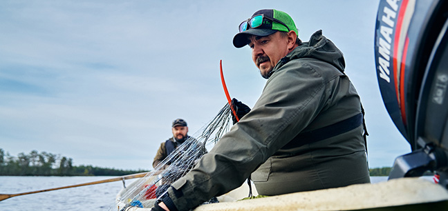 Two people in a boat fishing.