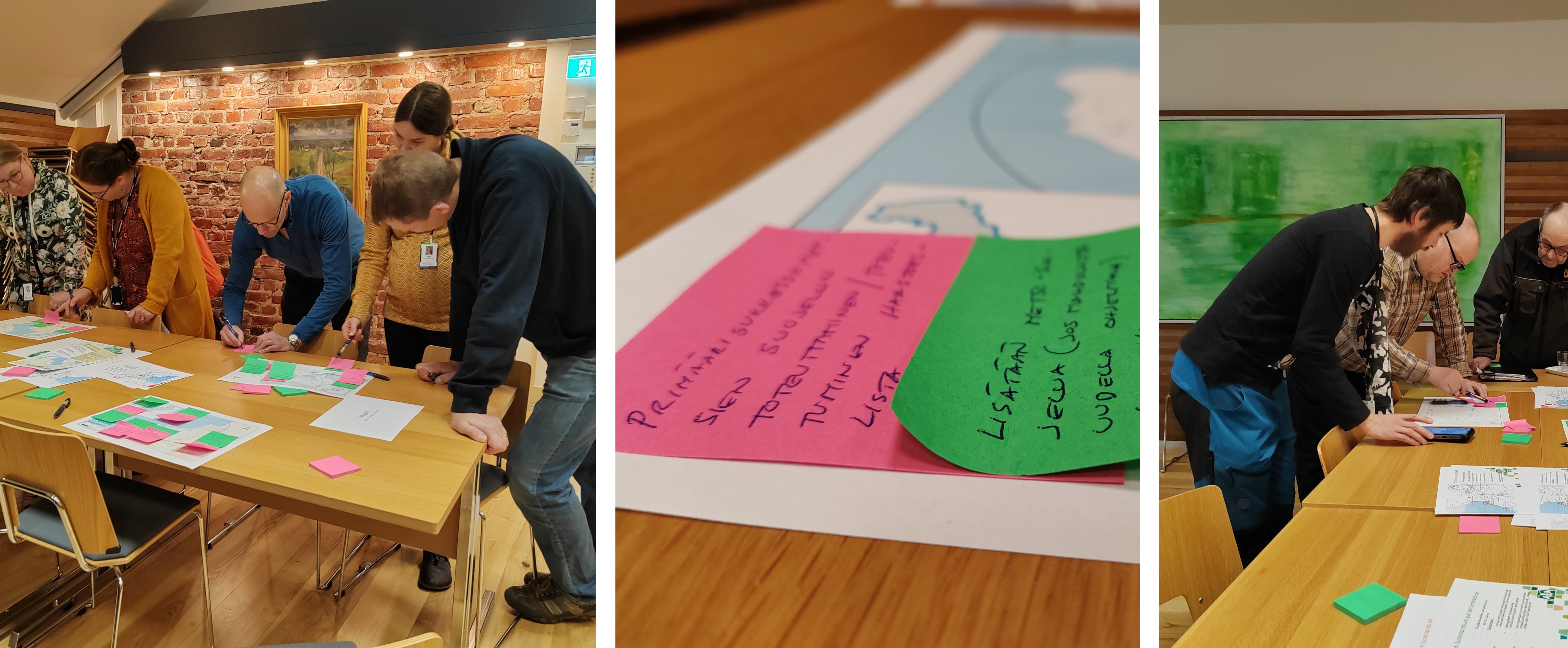 Ryhmä ihmisiä on kumartunut pöydän ylle. He kirjoittavat ja katsovat muistilappuja, joita on aseteltu isompien karttakuvien päälle.